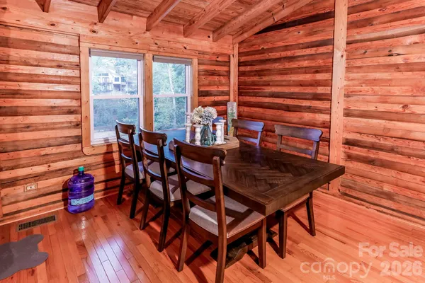 a dining room with furniture and wooden floor