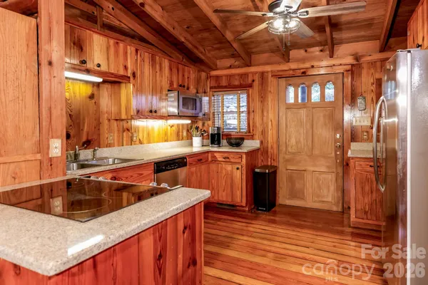 a kitchen that has a sink a refrigerator and window
