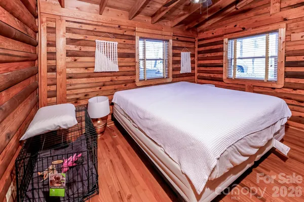 a bed sitting in a bedroom next to a window