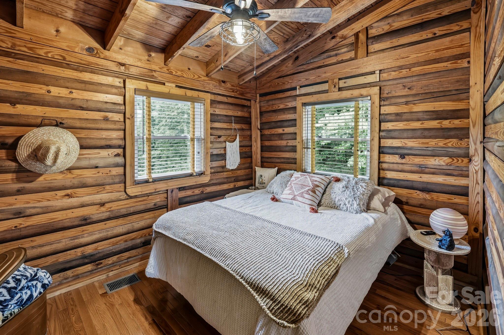 118 Rock Pt Road Lake Lure, NC 28746 - Photo 17 of 31 a bed sitting in a bedroom next to a window
