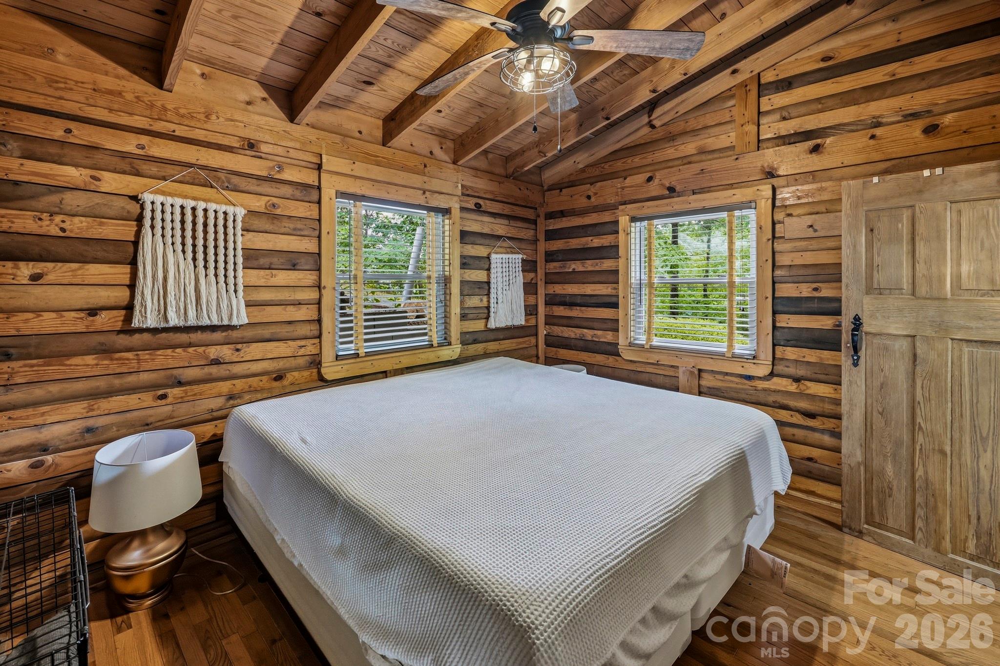 118 Rock Pt Road Lake Lure, NC 28746 - Photo 19 of 31 a large bed sitting in a bedroom next to a window and chair