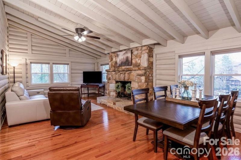 118 Rock Pt Road Lake Lure, NC 28746 - Photo 10 of 31 a living room with furniture a flat screen tv and a fireplace