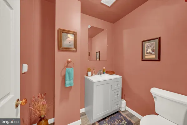 a bathroom with a sink mirror vanity and toilet