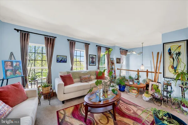 a living room with furniture and a potted plant