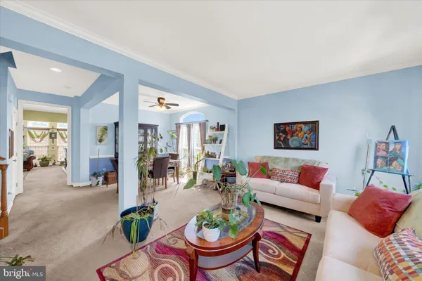 a living room with furniture fireplace and a large mirror
