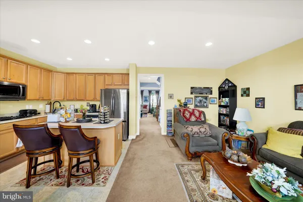 a kitchen with stainless steel appliances kitchen island granite countertop a table and chairs in it