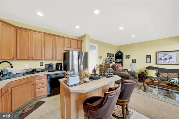 a kitchen that has a lot of cabinets a sink and appliances in it