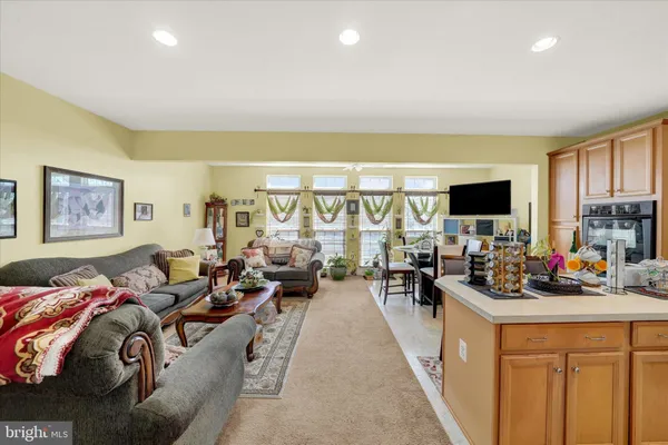 a living room with furniture a large window and a flat screen tv