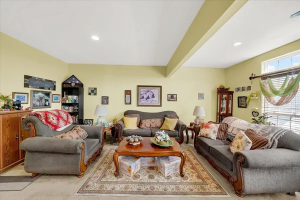 a living room with furniture a rug and a chandelier