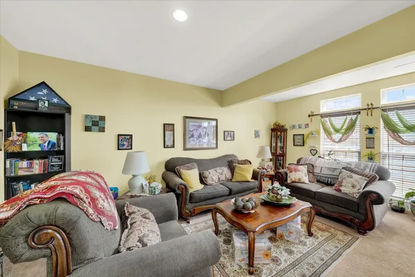 a living room with furniture and a mirror