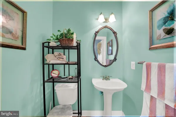 a bathroom with a sink mirror and toilet