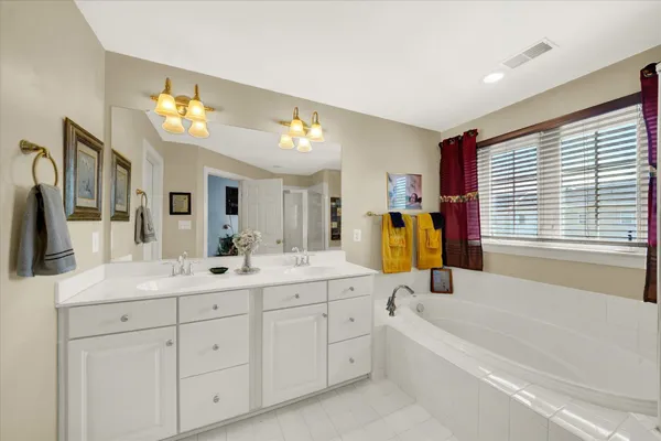 a bedroom with a bed and a large mirror