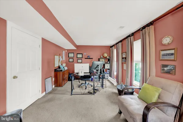 a dining room with furniture and a floor to ceiling window