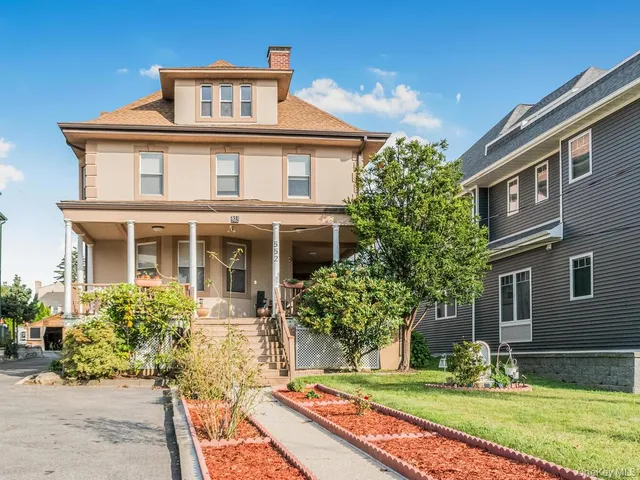 a front view of a house with garden