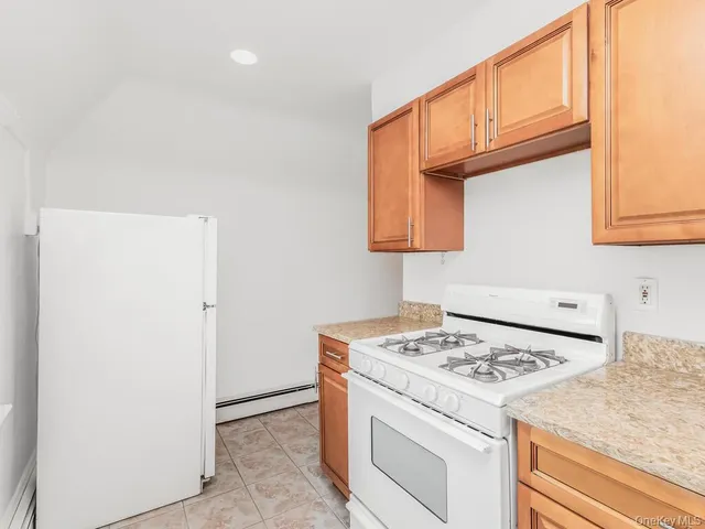 a kitchen with granite countertop cabinets appliances and a sink