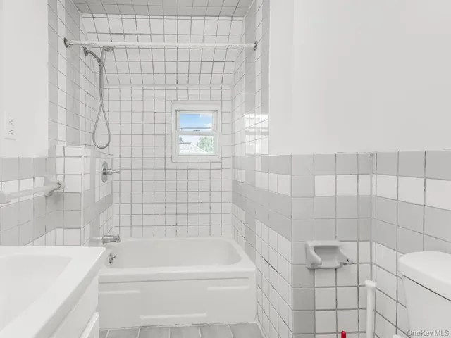 a bathroom with a bathtub and shower