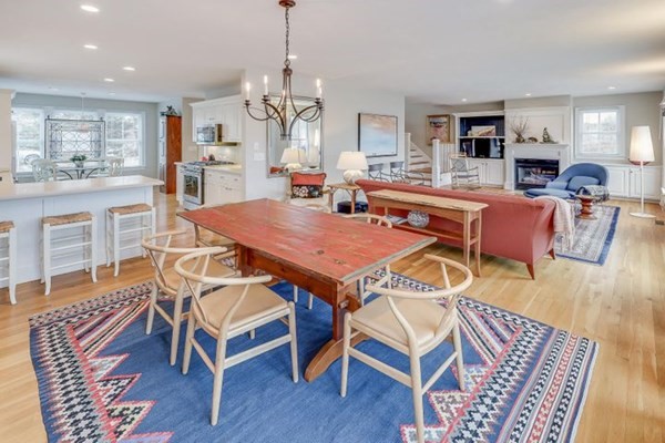7 Cod Lane, Unit 7 Harwich, MA 02646 - Photo 14 of 41 a dining room with wooden floor a chandelier a wooden table and chairs