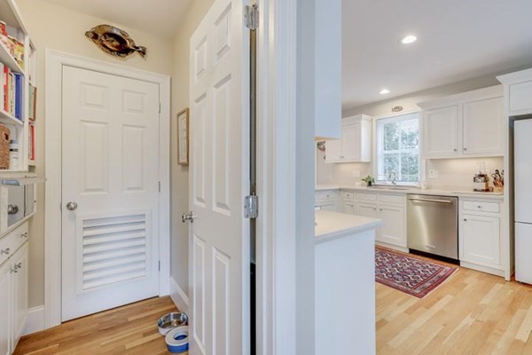 7 Cod Lane, Unit 7 Harwich, MA 02646 - Photo 23 of 41 a kitchen with white cabinets and white appliances