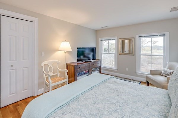 7 Cod Lane, Unit 7 Harwich, MA 02646 - Photo 33 of 41 a bedroom with furniture and a flat screen tv