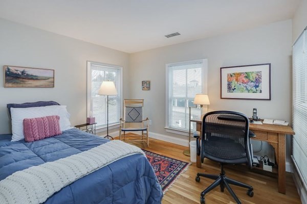 7 Cod Lane, Unit 7 Harwich, MA 02646 - Photo 36 of 41 a bedroom with a bed and chair