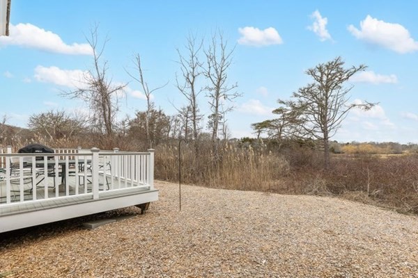 7 Cod Lane, Unit 7 Harwich, MA 02646 - Photo 9 of 41 a view of a yard with lake view and wooden fence