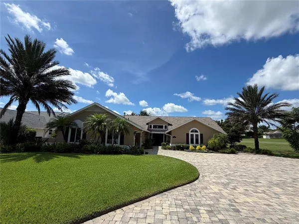 a front view of house with yard and green space
