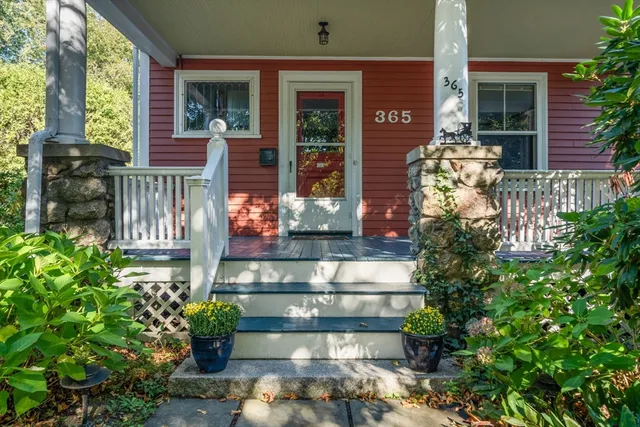 a front view of a house with a fountain