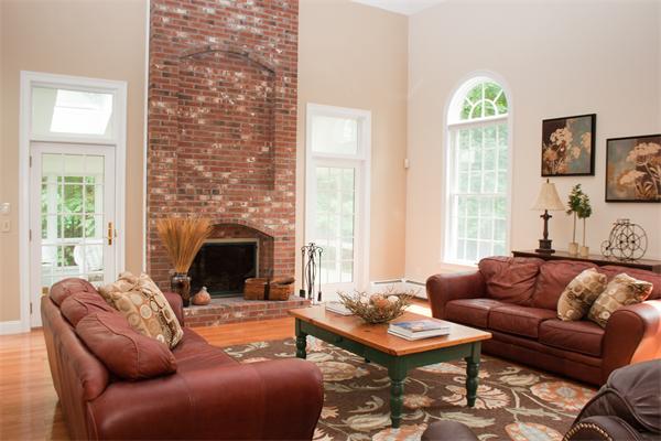 110 Kimball Road Carlisle, MA 01741 - Photo 3 of 25 a living room with furniture a fireplace and a table