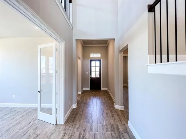 a view of a hallway with wooden floor