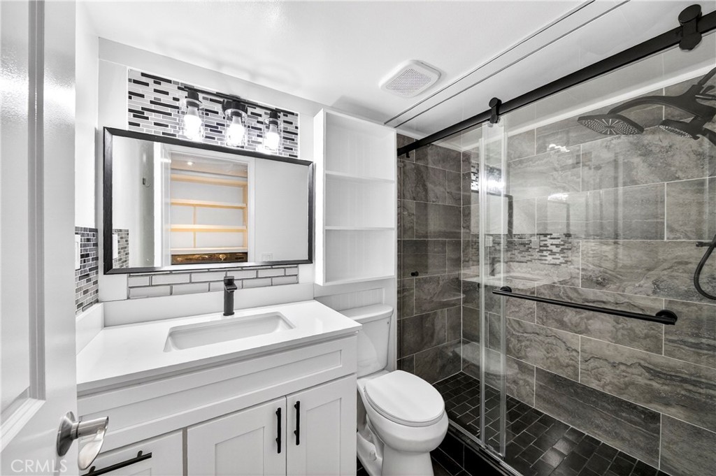 9 Madrona Irvine, CA 92612 - Photo 17 of 38 a bathroom with a sink a toilet and shower