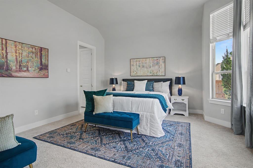 1101 Claiborne Drive Aubrey, TX 76227 - Photo 15 of 40 a bedroom with a bed and a table in it