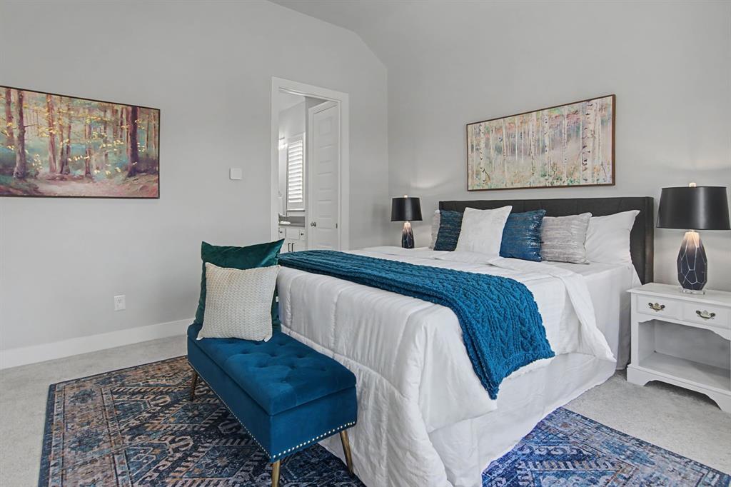 1101 Claiborne Drive Aubrey, TX 76227 - Photo 16 of 40 a bedroom with bed and night stand