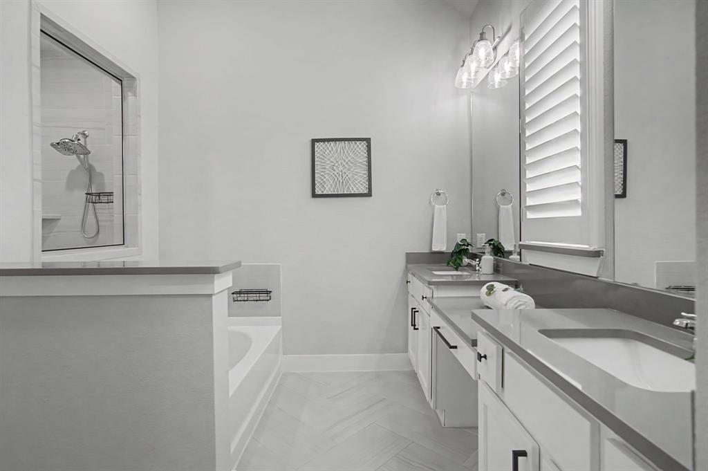 1101 Claiborne Drive Aubrey, TX 76227 - Photo 17 of 40 a spacious bathroom with 2 sink and a mirror