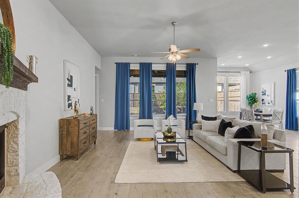 1101 Claiborne Drive Aubrey, TX 76227 - Photo 4 of 40 a living room with furniture a chandelier and a dining table with garden view