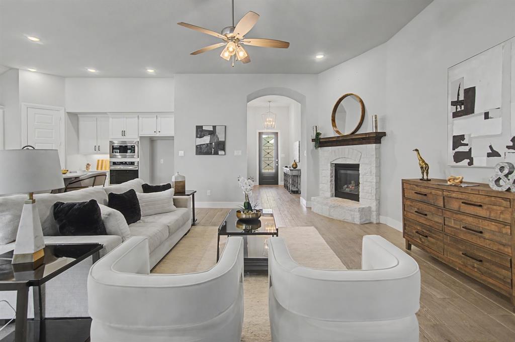 1101 Claiborne Drive Aubrey, TX 76227 - Photo 6 of 40 a living room with furniture and a fireplace