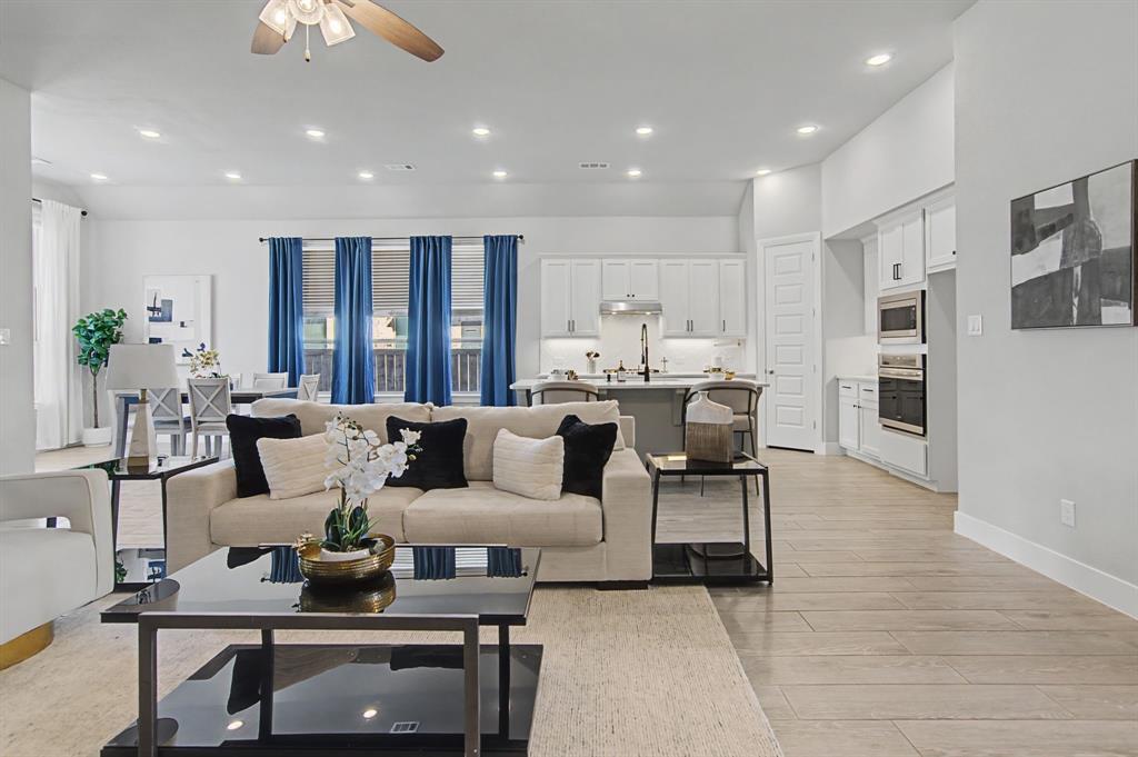 1101 Claiborne Drive Aubrey, TX 76227 - Photo 8 of 40 a living room with furniture kitchen view and a chandelier