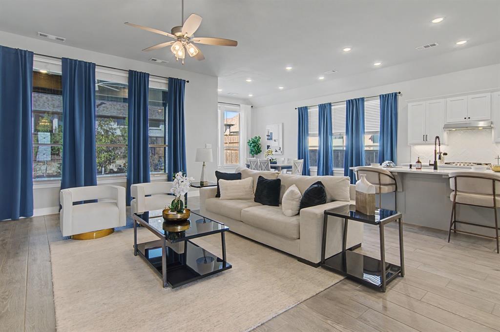 1101 Claiborne Drive Aubrey, TX 76227 - Photo 9 of 40 a living room with furniture and large windows