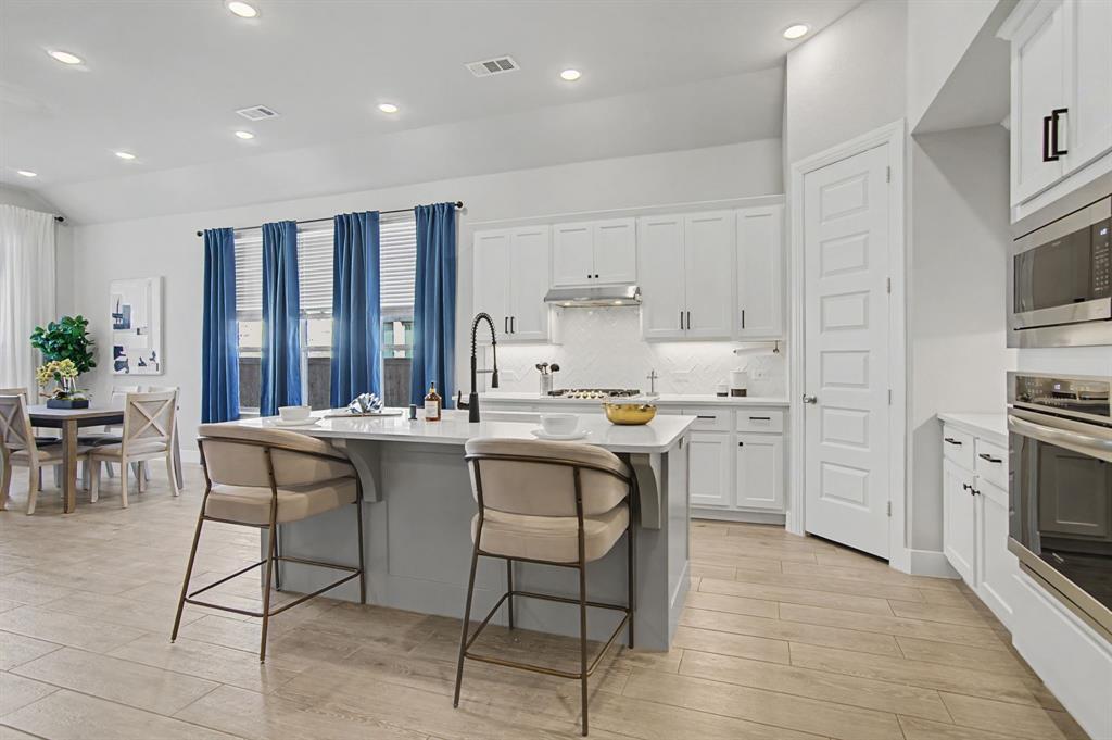 1101 Claiborne Drive Aubrey, TX 76227 - Photo 10 of 40 a kitchen with a sink cabinets and window