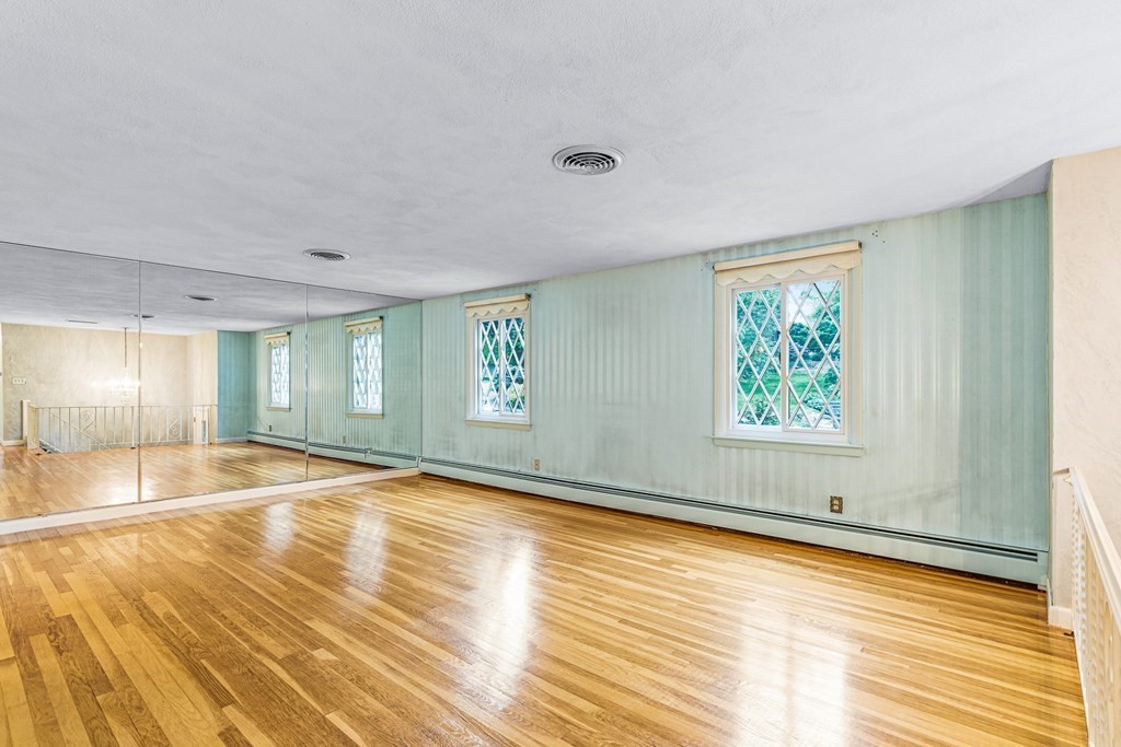 17 Gerald Road Marblehead, MA 01945 - Photo 8 of 36 a view of an empty room with window and wooden floor