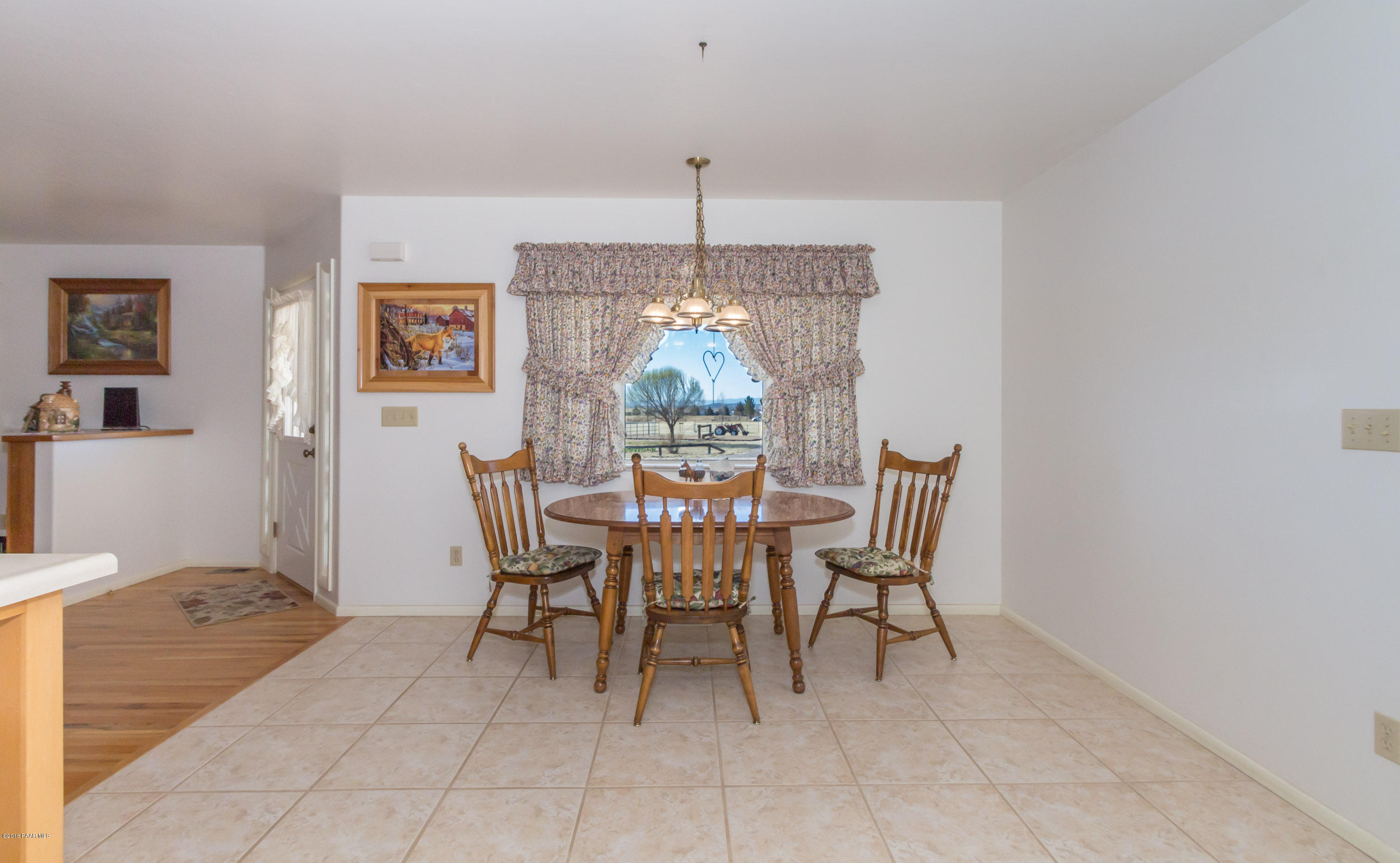 1050 Ranch House Road Paulden, AZ 86334 - Photo 9 of 19 a dining room with furniture a chandelier and window