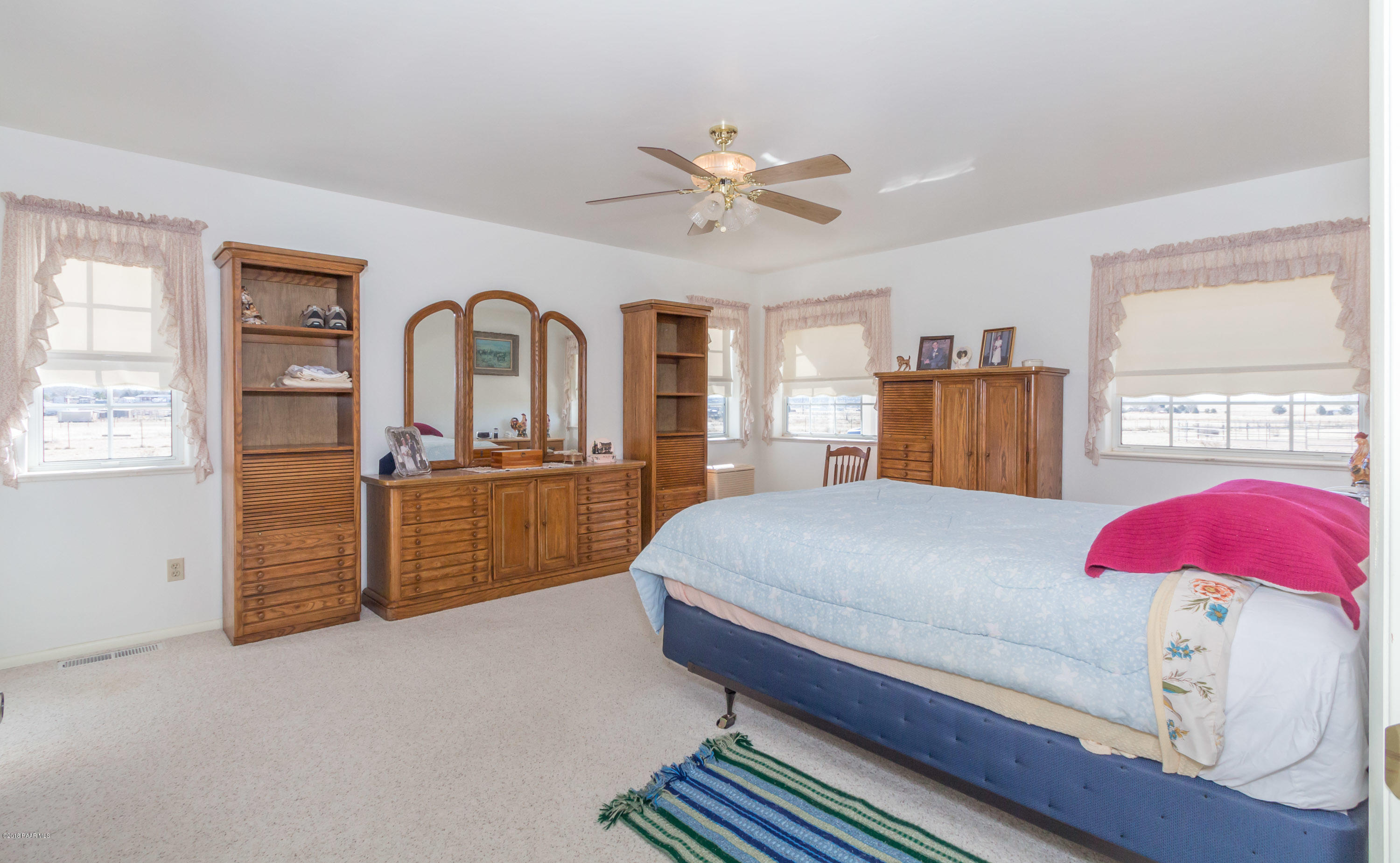 1050 Ranch House Road Paulden, AZ 86334 - Photo 10 of 19 a bedroom with a bed and dresser with mirror