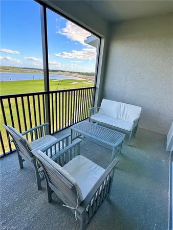 a balcony with chairs and wooden floor