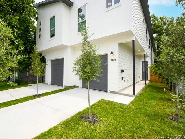 a view of a house with a yard and garage