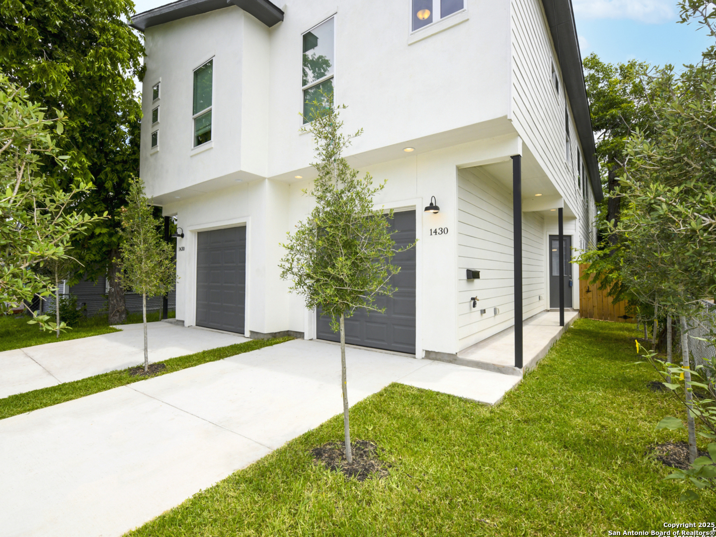 a view of a house with a yard and garage
