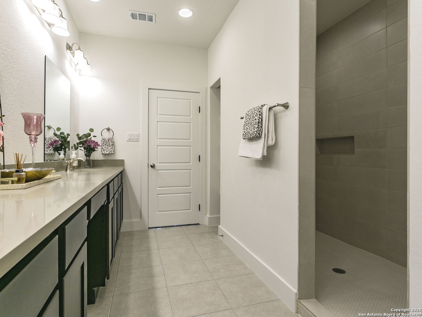 1430 Hays Street, Unit 101 San Antonio, TX 78202 - Photo 13 of 25 a bathroom with a sink vanity and mirror