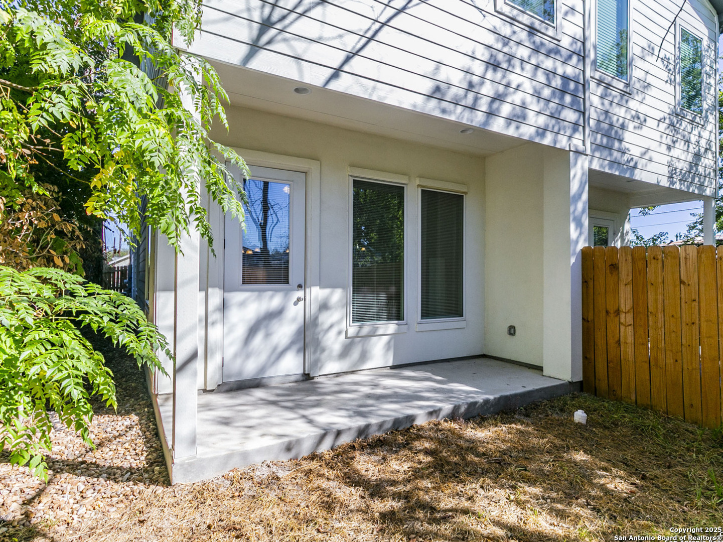 1430 Hays Street, Unit 101 San Antonio, TX 78202 - Photo 18 of 25 a view of a white house with a large tree