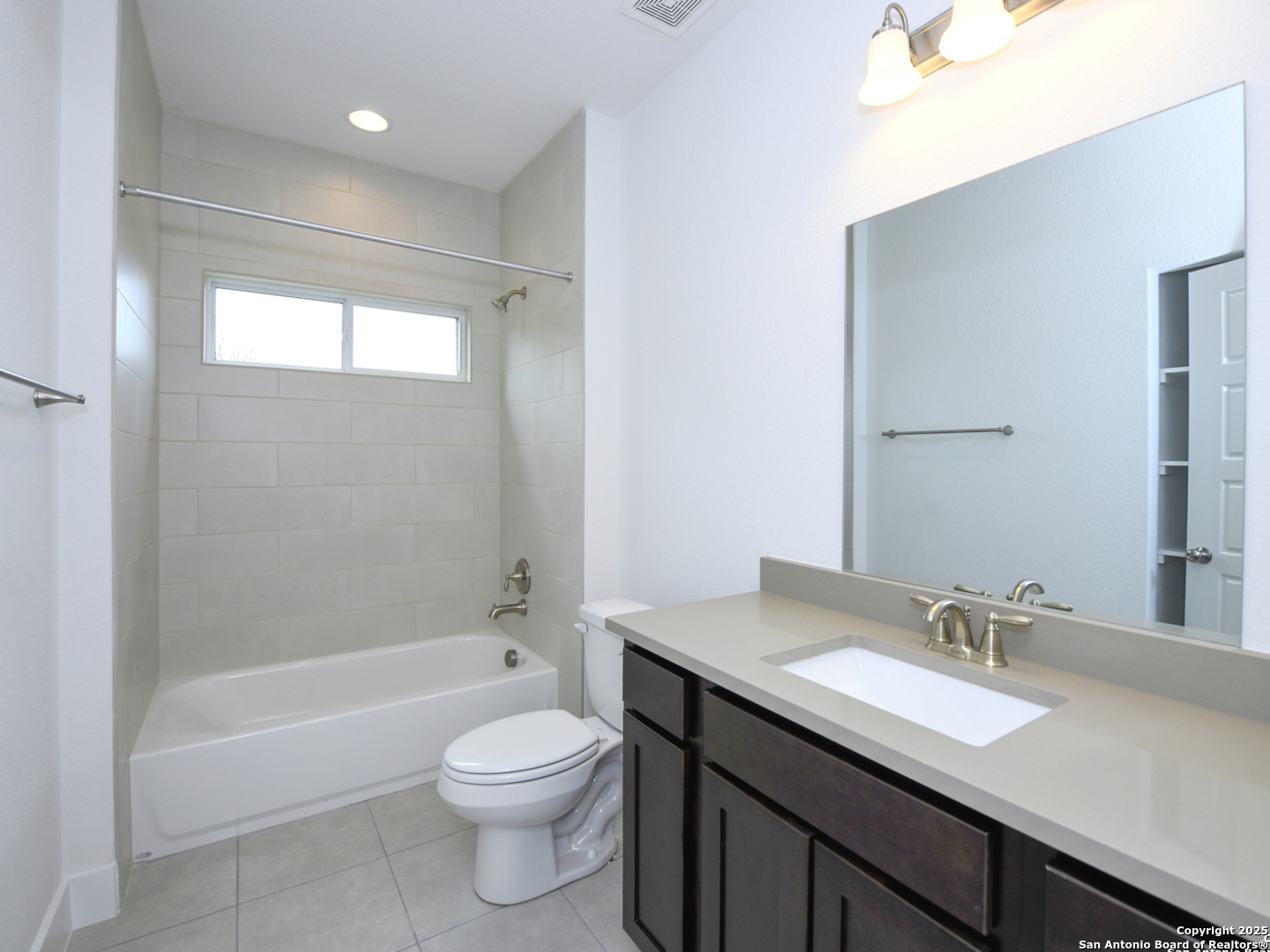 1430 Hays Street, Unit 101 San Antonio, TX 78202 - Photo 22 of 25 a bathroom with a granite countertop sink a toilet and shower