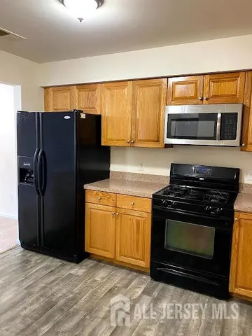 a kitchen with a refrigerator and a stove