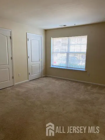 a bathroom with a granite countertop sink and a toilet