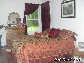 1762 Summerdean Road Middlebrook, VA 24459 - Photo 7 of 11 a large bed sitting in a bedroom next to a window
